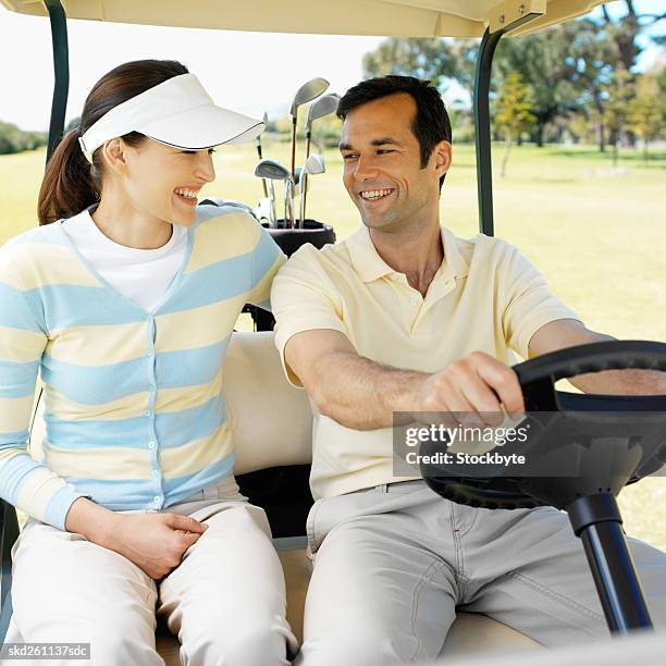 two golfers in a golf cart - fahrspaß stock-fotos und bilder