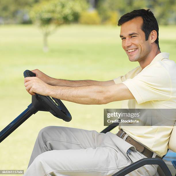 golfer sitting in a golf cart - fahrspaß stock-fotos und bilder