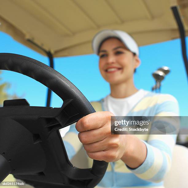 golfer sitting in a golf cart - fahrspaß stock-fotos und bilder