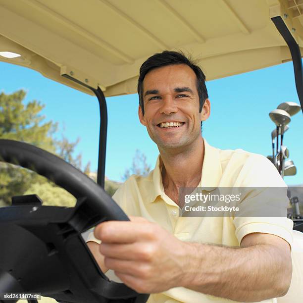 golfer sitting in a golf cart - fahrspaß stock-fotos und bilder