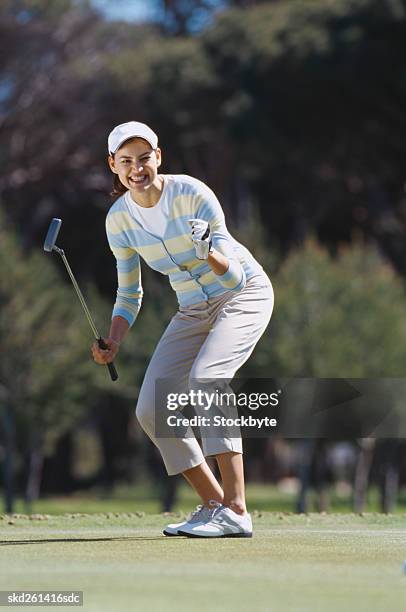 young woman cheering after a shot of golf - after stock pictures, royalty-free photos & images