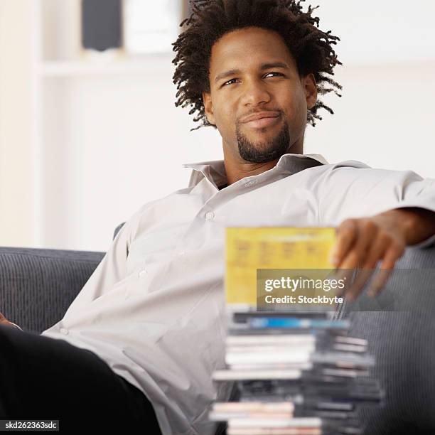 close-up of young man looking at collection of cds - kmart and shop your way celebrate launch of nicki minaj collection stockfoto's en -beelden