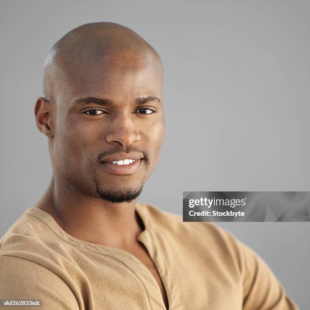front view portrait of young man smiling - goatee stock-fotos und bilder