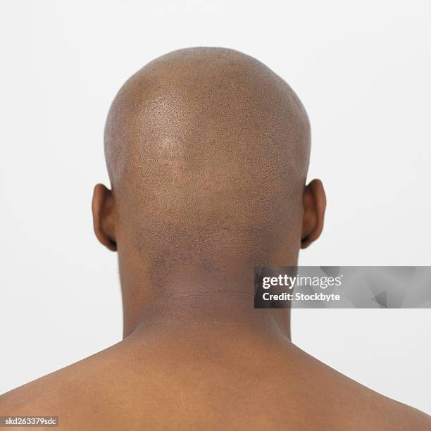 rear view of bare-chested young man - bare stock-fotos und bilder