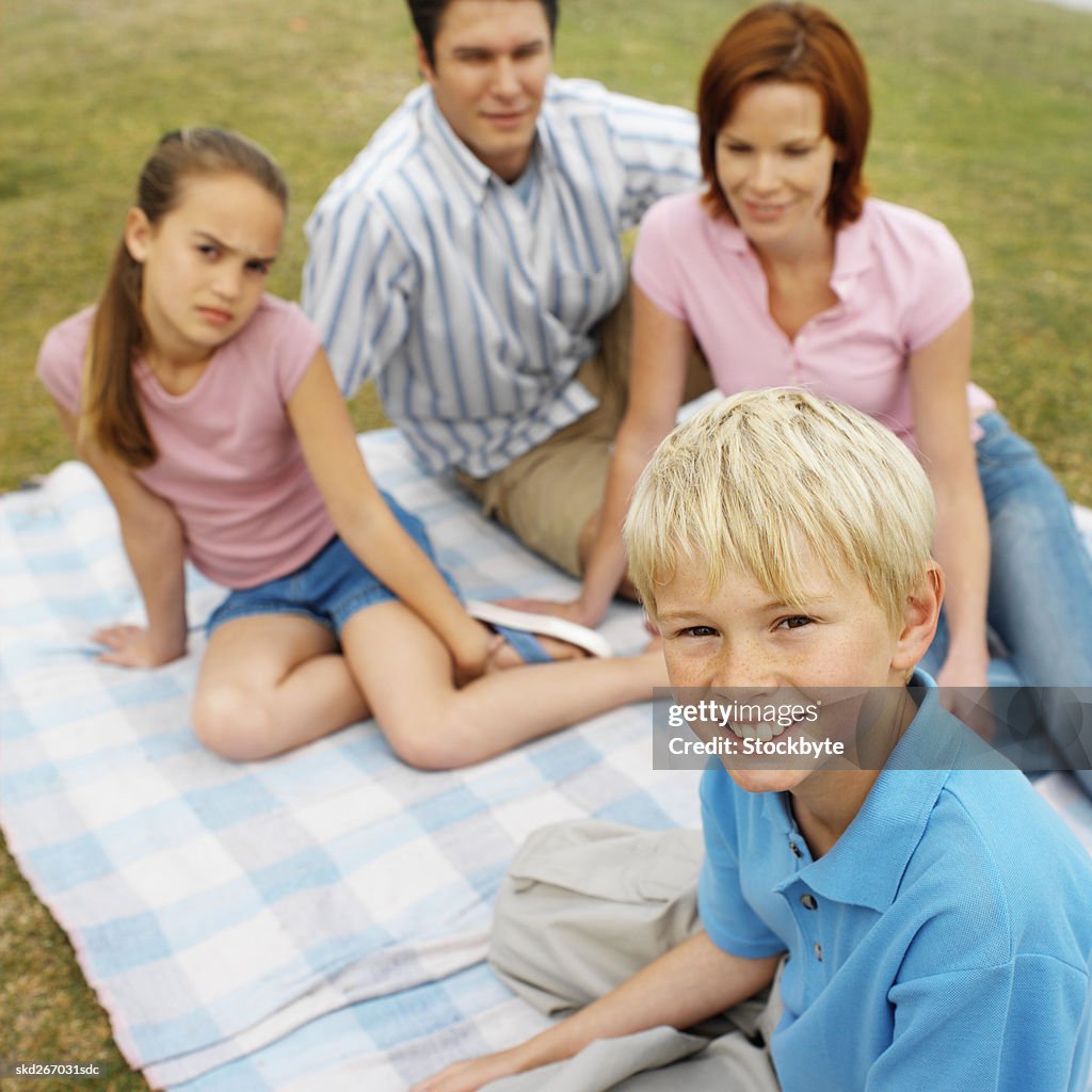 Portrait of a family sitting on a blanket