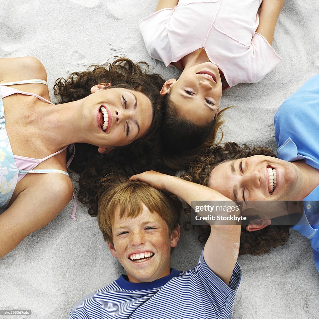 Family at the beach lying on the sand