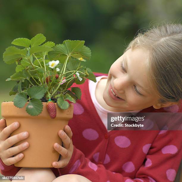 close-up of girl holding pot plant (10-11) - pot plant stock pictures, royalty-free photos & images