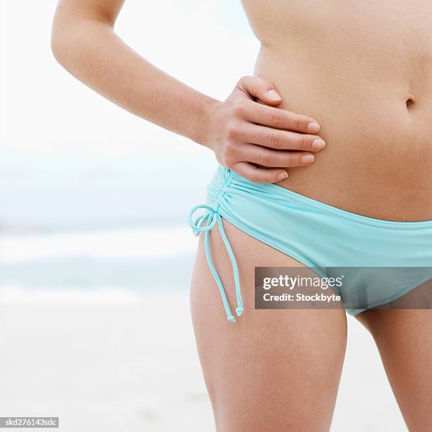 close-up mid section of a woman at the beach - arms akimbo stock pictures, royalty-free photos & images