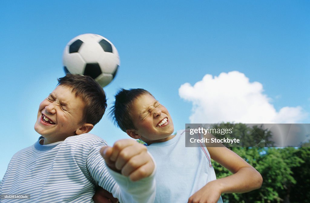 Boys (10-12) playing football