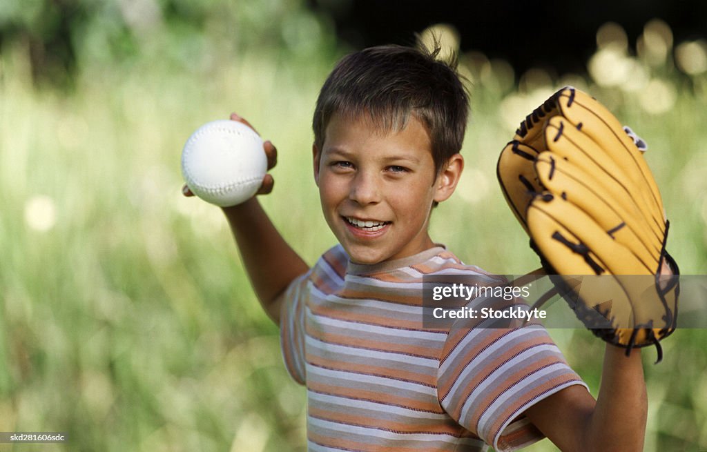 Boy (11-12) throwing baseball