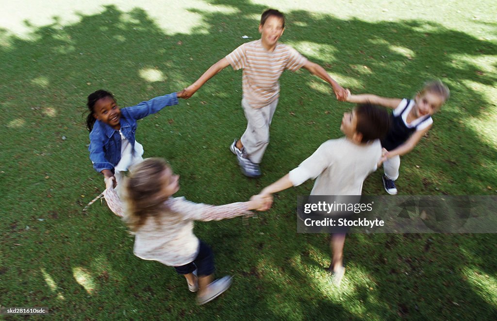 Children playing ring a rosy