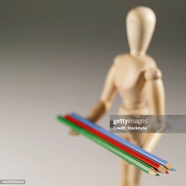 artist's mannequin holding coloring pencils - modell stock pictures, royalty-free photos & images