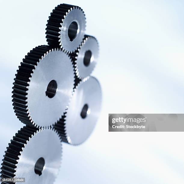 close-up of five cogs - movimiento perpetuo fotografías e imágenes de stock