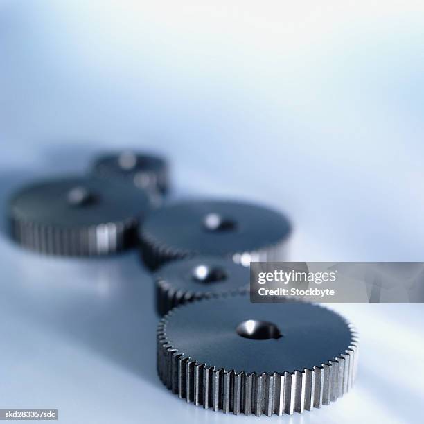 close-up of five cogs - movimiento perpetuo fotografías e imágenes de stock
