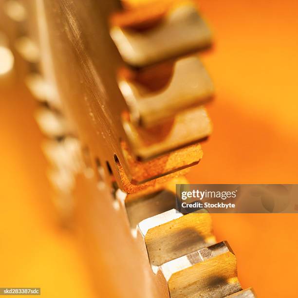 close-up of three cogs - movimiento perpetuo fotografías e imágenes de stock