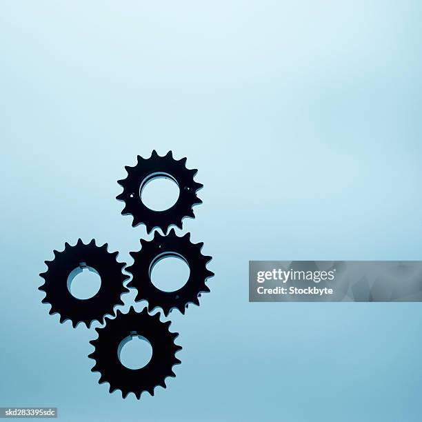 close-up of four cogs - movimiento perpetuo fotografías e imágenes de stock