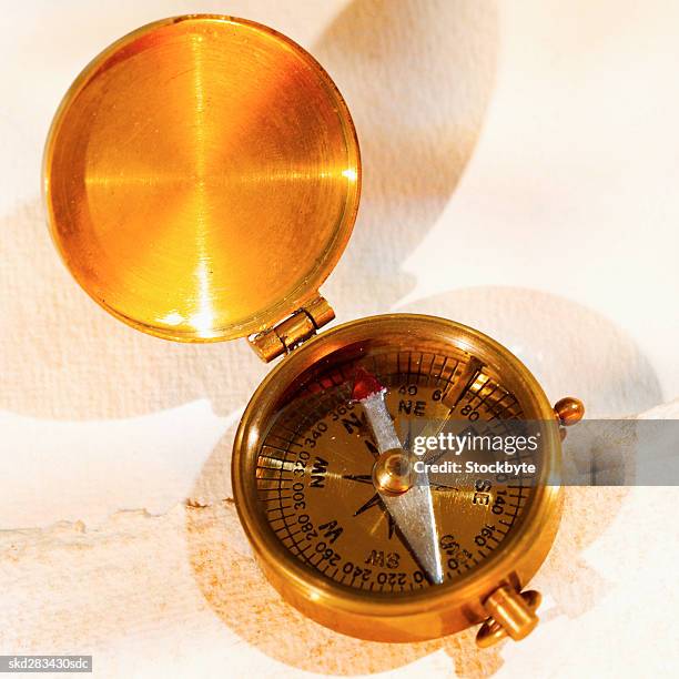 elevated view of travel compass - travel​ stock pictures, royalty-free photos & images