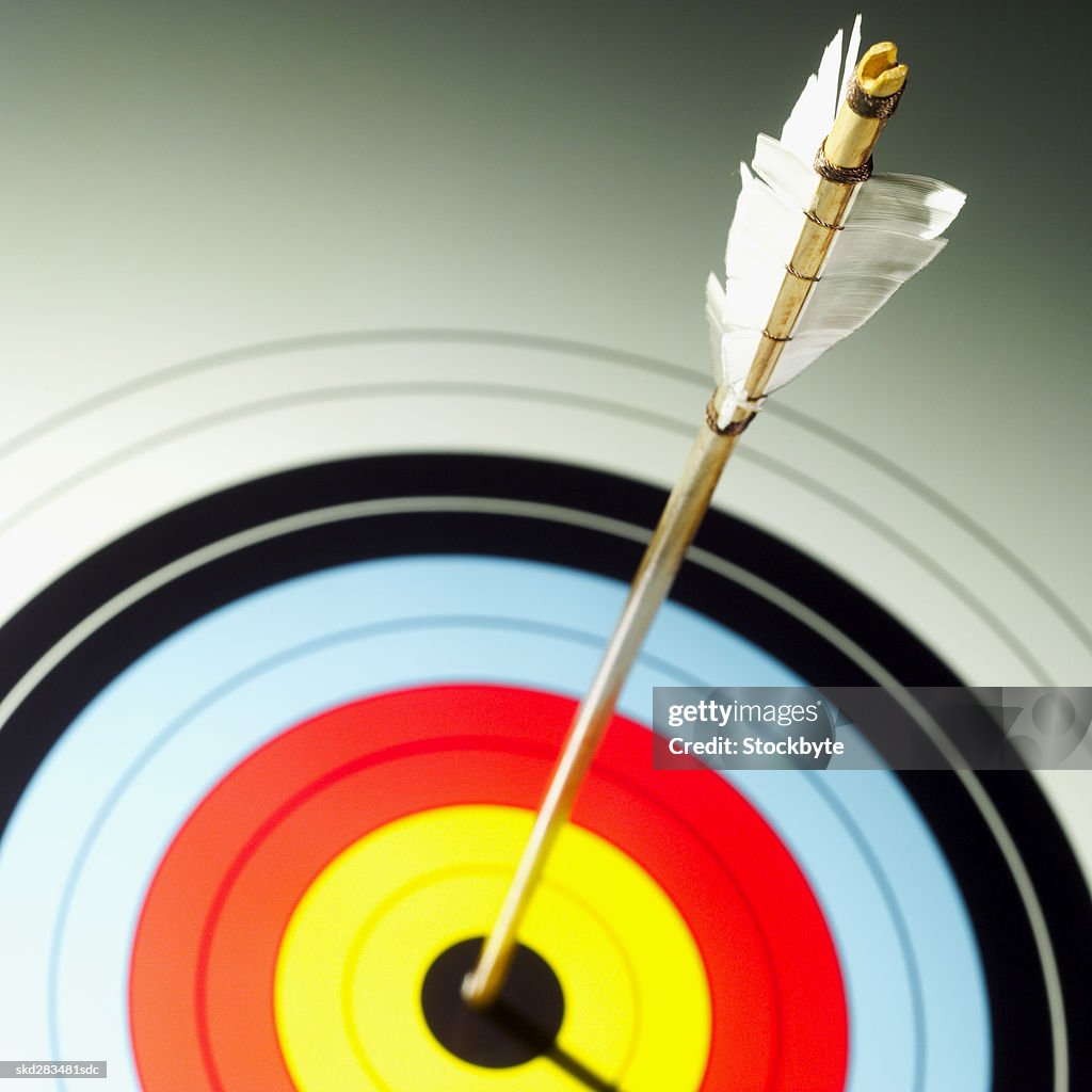 Close-up of arrow in bulls eye of target