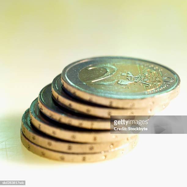 close-up of a stack of two euro coins - zwei euro münze stock-fotos und bilder