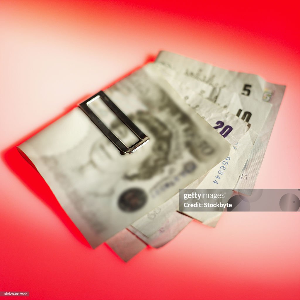 Close-up of various U.K.. pound notes held together with clip