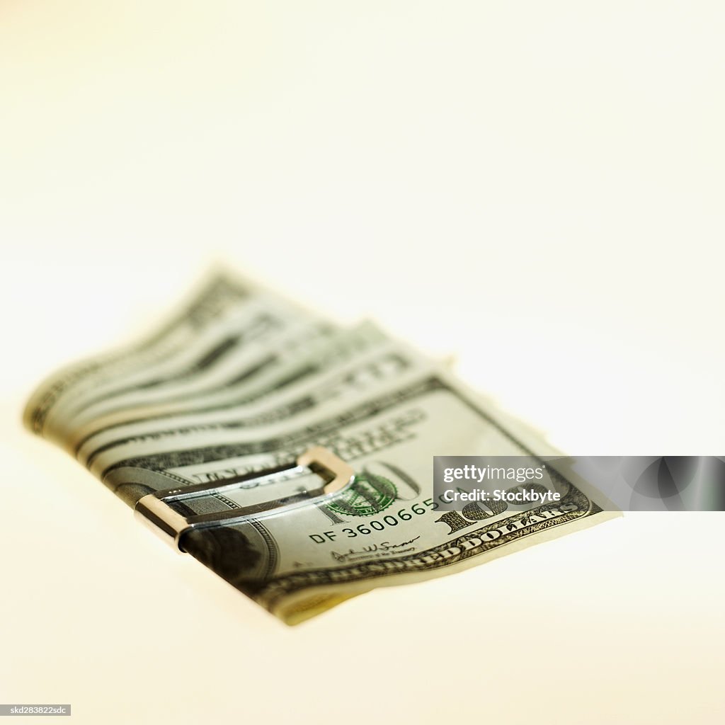 Close-up of various American dollar notes held together with clip