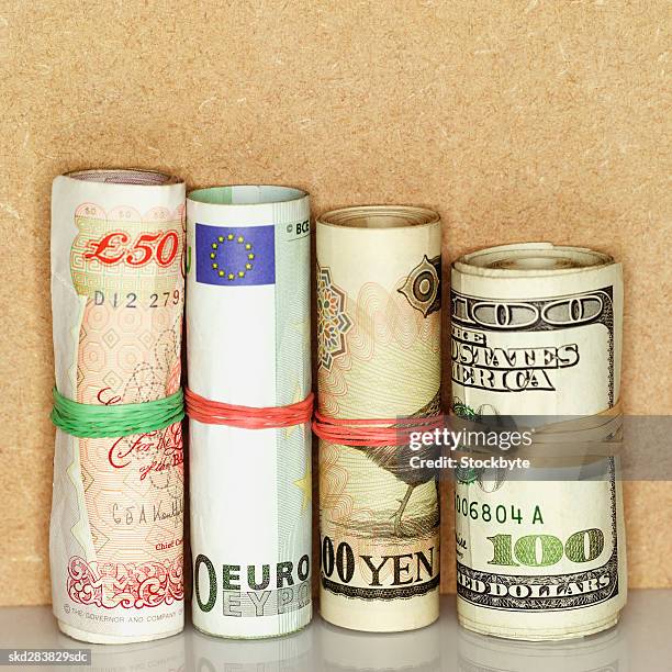 close-up of various currency bundles of bank notes bound with rubber band - ten thousand yen note stock pictures, royalty-free photos & images