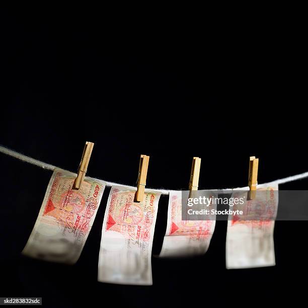 close-up of fifty pound notes hanging on clothesline - 50 pound notes stock pictures, royalty-free photos & images
