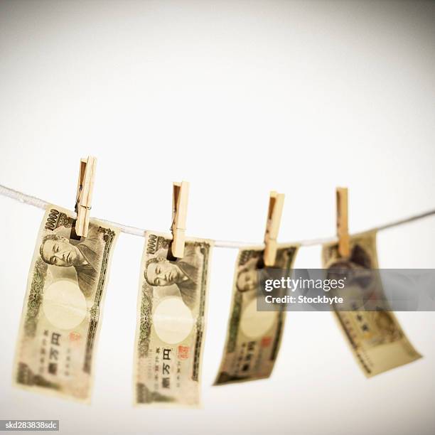 close-up of various japanese yen notes hanging on clothesline - only japanese ストックフォトと画像