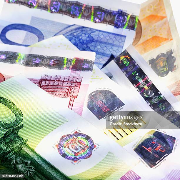 close-up of various euro notes hanging on clothesline - nota de duzentos euros - fotografias e filmes do acervo