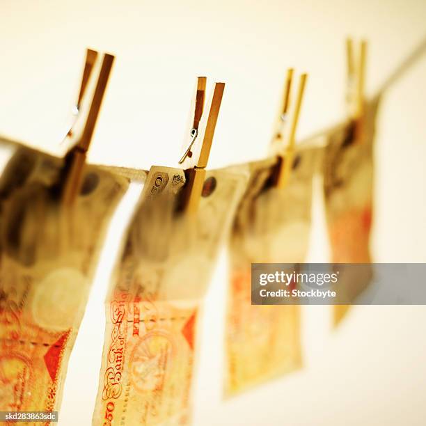 close-up of fifty pound notes hanging on clothesline - 50 pound notes stock pictures, royalty-free photos & images