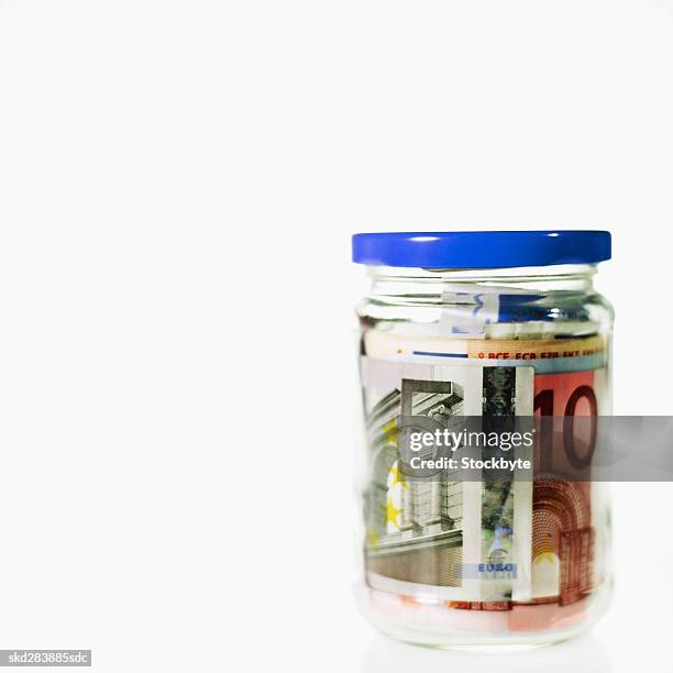 close-up of a jar containing euro bank notes - 50 euros stock-fotos und bilder