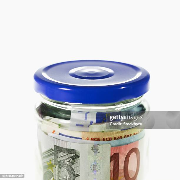 close-up of a jar containing euro bank notes - 50 euros stock-fotos und bilder