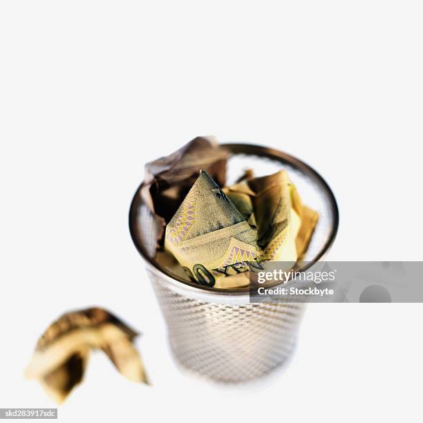 elevated view of crumpled japanese yen bank notes in rubbish bin - all asian currencies stock pictures, royalty-free photos & images