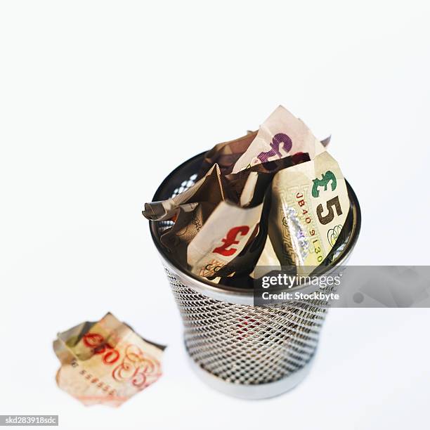elevated view of crumpled u.k.. pound notes in rubbish bin - 50 pound notes stock pictures, royalty-free photos & images