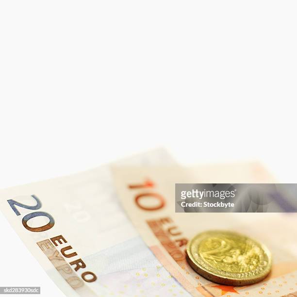 close-up of various euro notes and a two euro coin - twenty euro banknote stock pictures, royalty-free photos & images