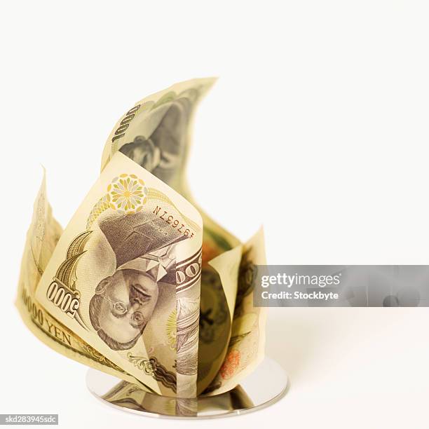 close-up of japanese yen bank notes going down the drain - five thousand yen note stock pictures, royalty-free photos & images