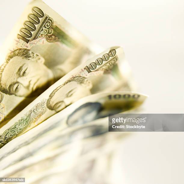 close-up of various japanese yen bank notes - ten thousand yen note stock pictures, royalty-free photos & images