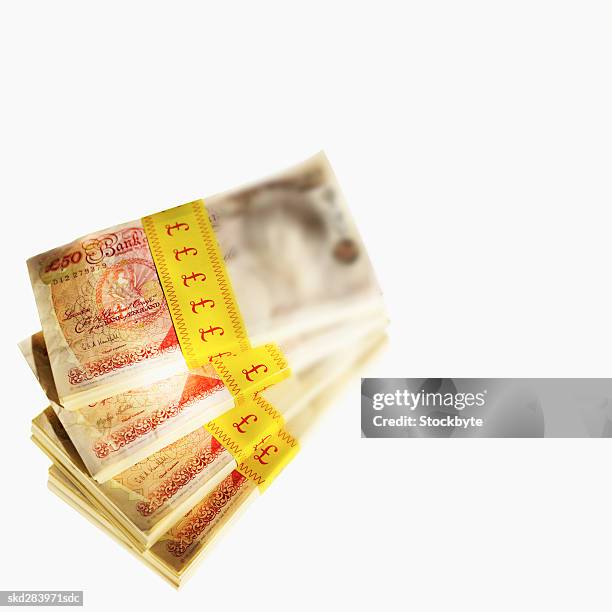 elevated view of stacks of u.k.. pound notes - 50 pound notes stock pictures, royalty-free photos & images