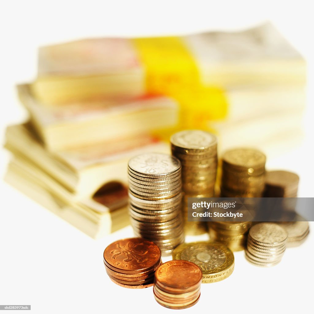 Close-up of stacks of U.K.. pound notes and coins