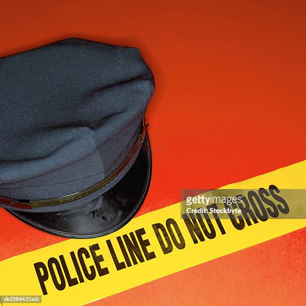 close-up of police tape and police hat - hat stock-fotos und bilder