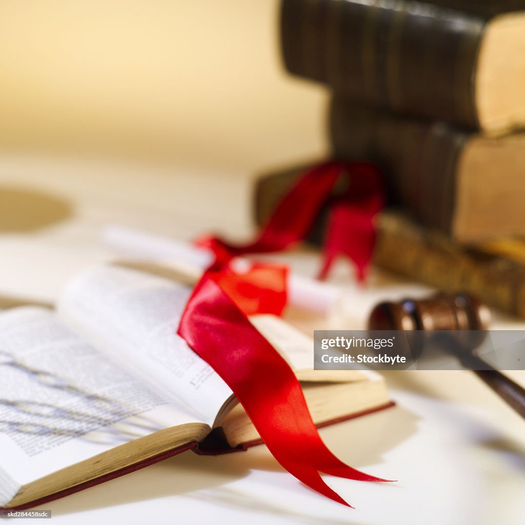 Close-up of textbooks and gavel and certificate