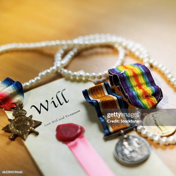 close-up of will with pearl necklace and army medals beside it - pearl imagens e fotografias de stock