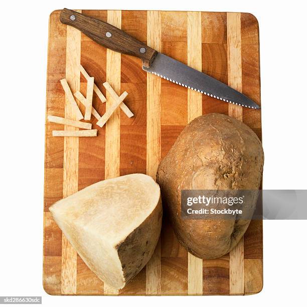 elevated view of sliced jicama and a knife on a cutting board - jicama stock pictures, royalty-free photos & images