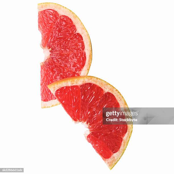 close-up of slices of a pink grapefruit - pink grapefruit stock pictures, royalty-free photos & images