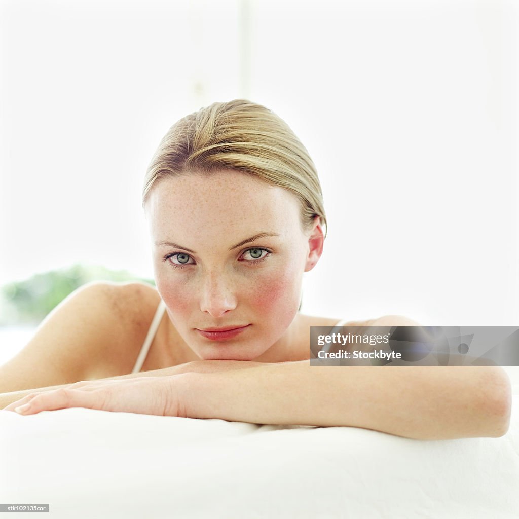 Portrait of a young woman sitting on a couch