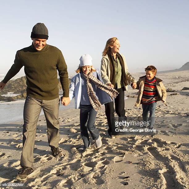 portrait of a family running at the beach - square neckline foto e immagini stock