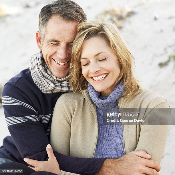 portrait of a couple holding each other and laughing - square neckline fotografías e imágenes de stock