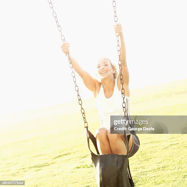 happy woman on a swing - happy stockfoto's en -beelden