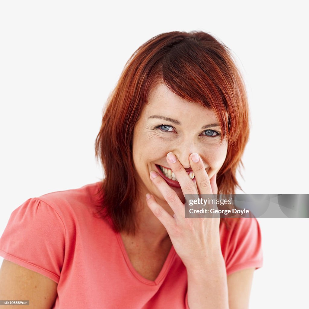 Portrait of a woman laughing with her hand over her mouth