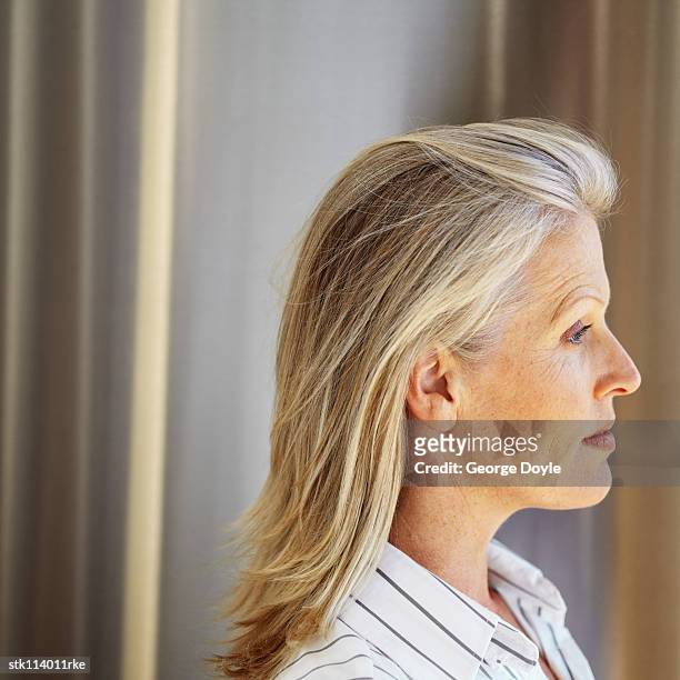side profile of an elderly woman looking ahead - ahead stock pictures, royalty-free photos & images
